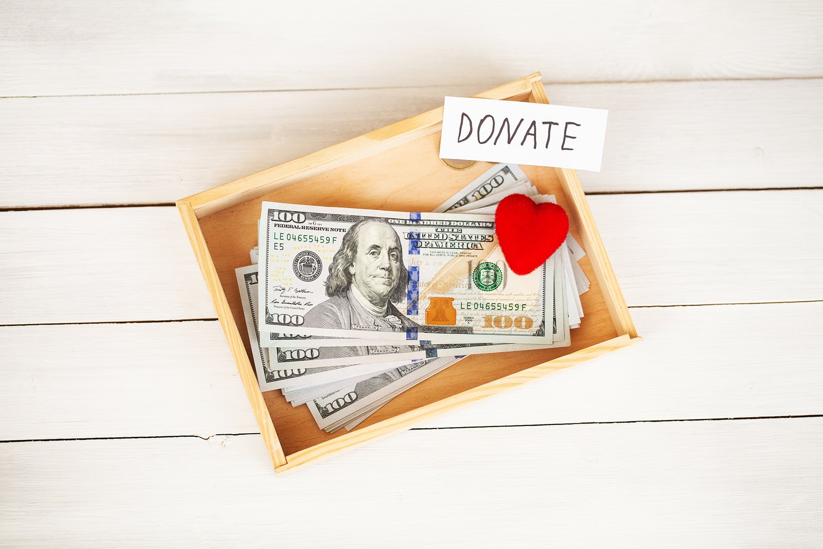 Donations and Charity. Donation Concept. Box of Donations and Heart on the White Background.